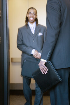 A young Business man smiling in an elevator
