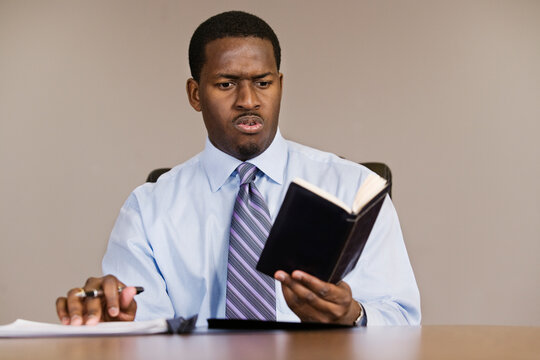 A Business man reading in an office