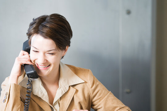 Business woman conversing over telephone