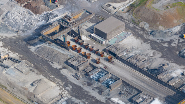 Aerial view of the Tata Steel industrial plant with heavy machinery, metal ladles, and raw material piles in Velsen-Noord, Noord-Holland, Netherlands.