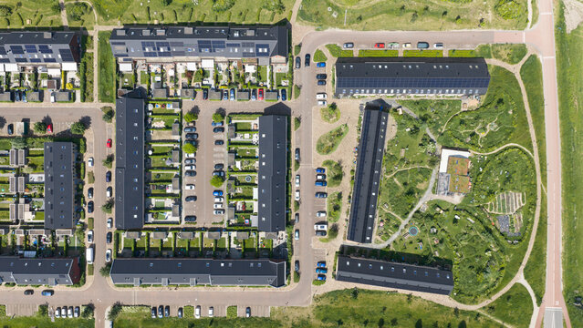 Aerial view of Ecodorp Zuiderveld featuring modern sustainable housing with solar panels, lush green gardens, and organized parking areas in Nijmegen, Gelderland, Netherlands.