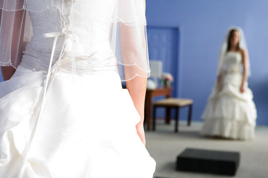 Midsection of a bride wearing a wedding gown