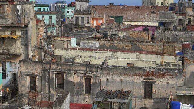 weathered Old Havana Cuba apartment blocks faded walls roof terraces and colorful buildings stacked tightly for urban decay and travel themes in daylight