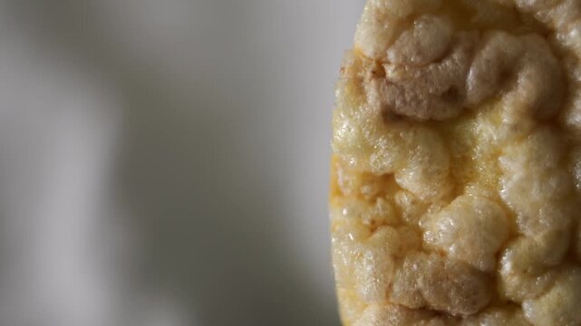 50p macro slider shot moving across a corn cake in side view