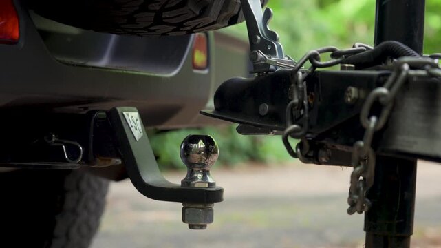 Reversing the vehicle to align the hitch and trailer.