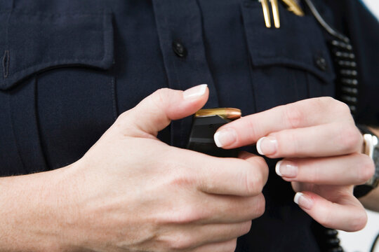 Cop loading bullets in the magazine