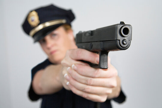 View of a police woman aiming with pistol