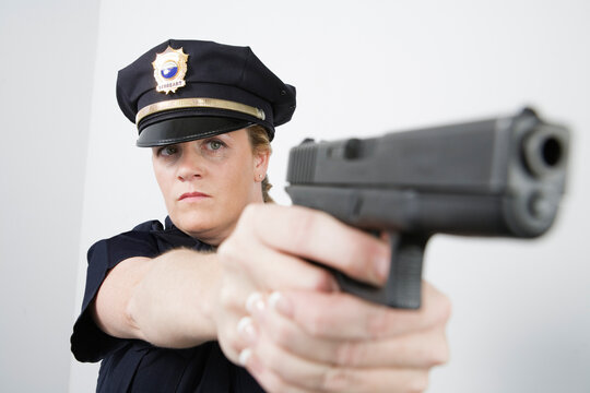 View of a police woman aiming with pisol