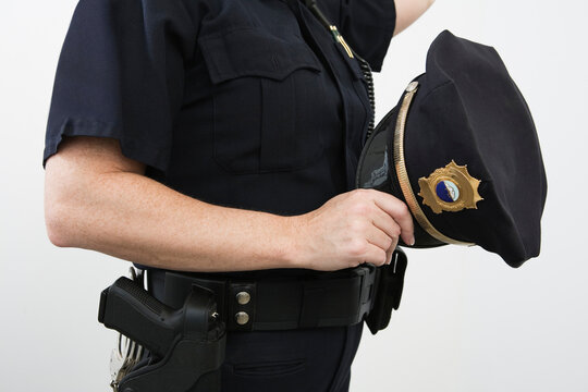 Close up of a police sergeant holding a cap
