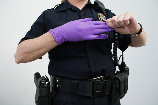 Woman police officer removing a glove