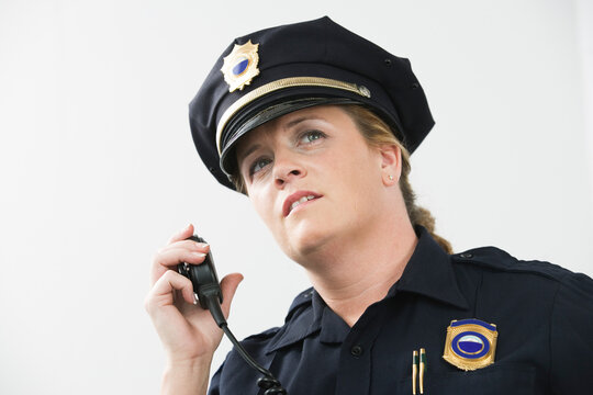 Woman police officer talking on hand mike