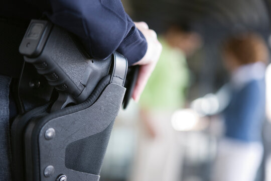 Close up of a female police woman's gun in holster