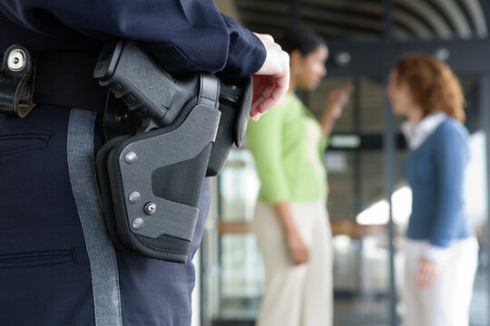 Close up of a female police womn's gun in holster