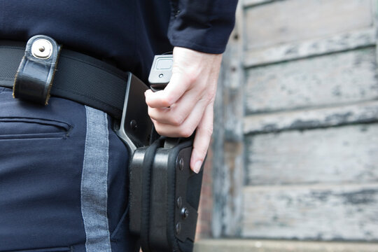 Close up of a female police woman drawing handgun from holster