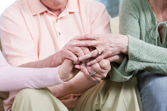 View of friends holding hands together