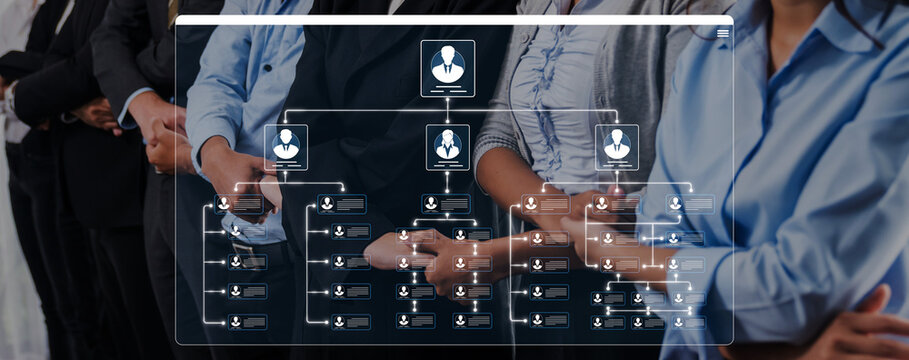 Business team collaborating on organizational structure with digital interface showing flowchart and employee connectivity in modern office setting Sigmoid