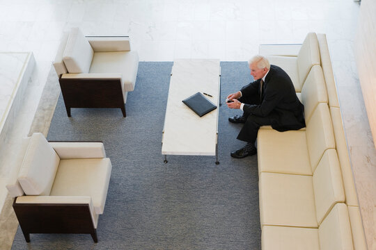Elevated view of a businessman sitting on a couch