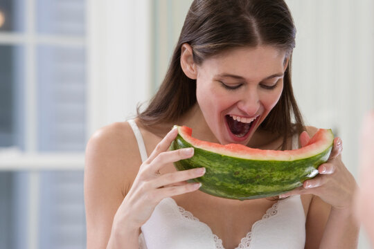 Young woman eating watermelon