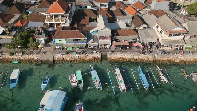 Local Boats Float On Crystal Clear Water Benoa Bay Waterfront Bali Indonesia Drone Static Shot 4K 30FPS