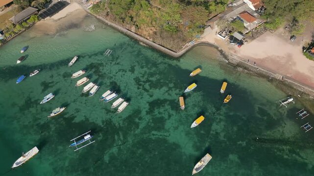 Local Boats Moored At Benoa Beach Bali Indonesia Drifting Clear Blue Water Drone Track Left 4K 30FPS