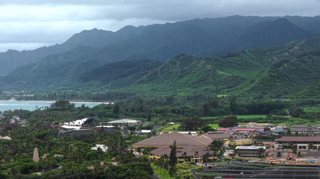 View over lush green Laie valley, coastline, and campus buildings on Oahu, Hawaii