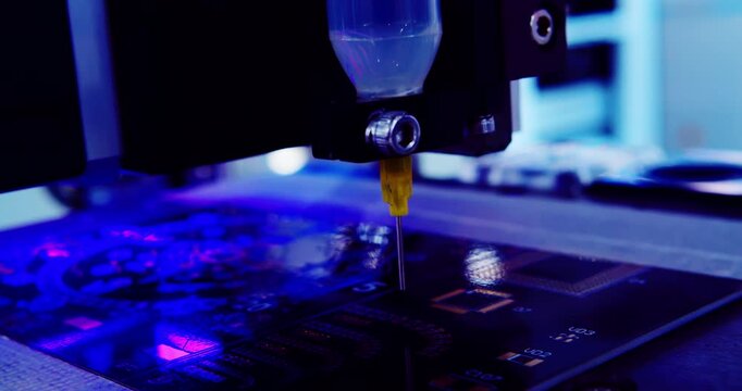Macro close-up of a robotic arm applying solder paste on a circuit board. High-tech industrial production.Artificial light.Cinematic shot of precision automated PCB assembly line. 