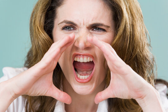 Close-up of a mid adult woman yelling