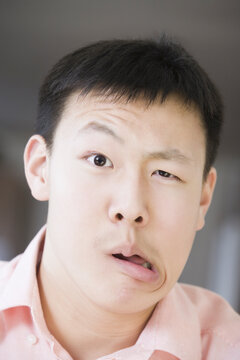 Portrait of a teenage boy making a face
