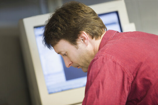 Close-up of a mid adult man working in a control room