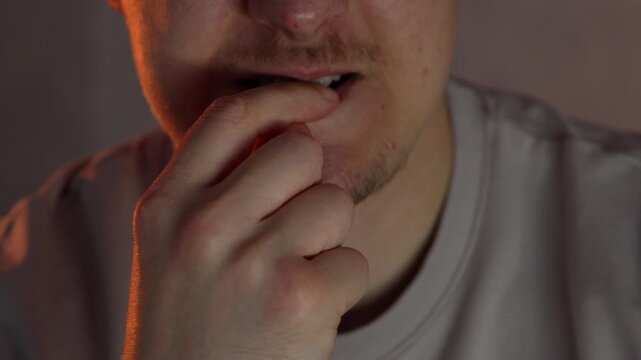 A person bites their fingernails.
A gesture of worry and anxiety.
A person feels anxious and bites their fingernails.