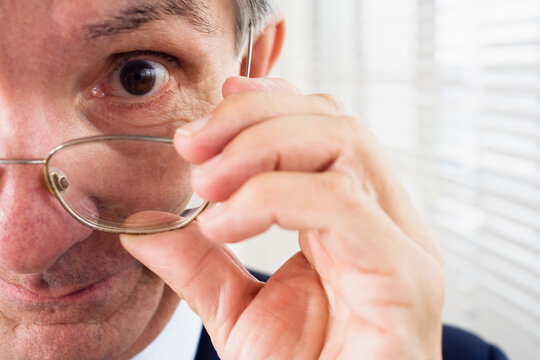 Close up of a man holding glasses