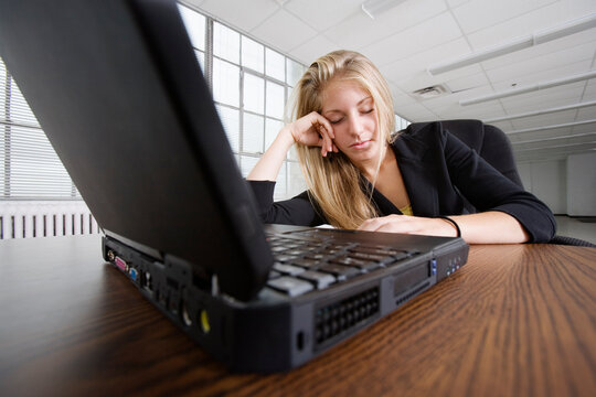 A business woman relaxing in front of a laptop