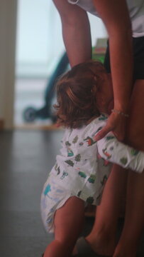 Toddler reaching to be picked up by mother at home, emotional attachment and caregiving concept, child seeking comfort and parental response in intimate family moment