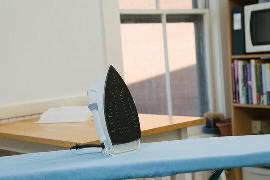 Close-up of an iron on an ironing board