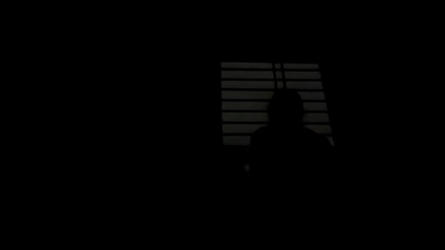 A girl watching the illuminating sky due o the thunderstorm outside, Maharashtra
