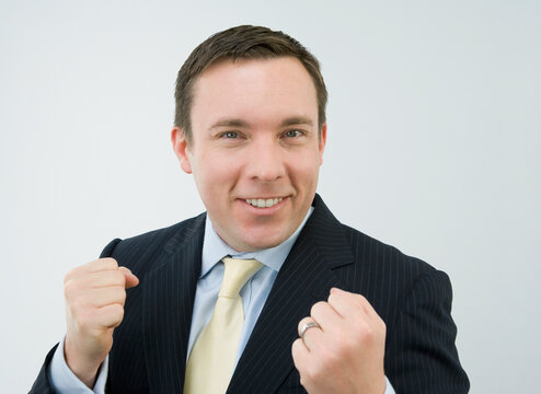 Portrait of a businessman clenching his fists and smiling