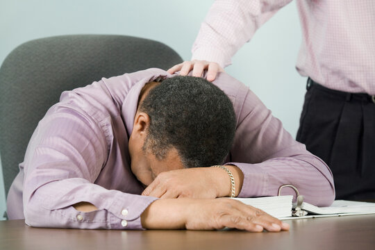 Mid section view of a businessman consoling his colleague