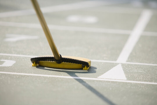 Close-up of a shuffleboard cue