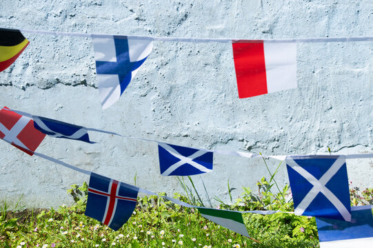 Scottish bunting and World Cup-themed flag decorations displayed during football tournament celebrations. Blue and white Scottish Saltire flags combined with festive World Cup bunting create a vibrant