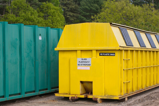 Recycling container used for plastic and glass near a trash container