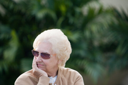 Close-up of a senior woman with her hand on her chin