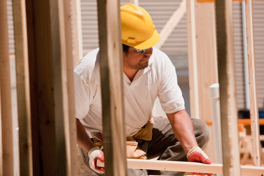 Carpenter placing wall studs