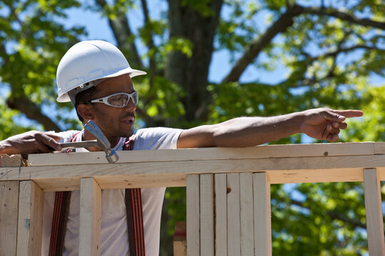 Carpenter working on a frame at a construction site