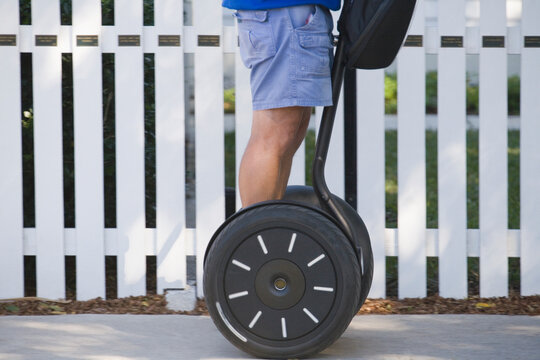 Mid section view of a man riding a segway