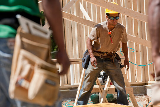 Carpenters working on a framed house