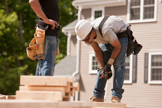 Carpenters marking studs
