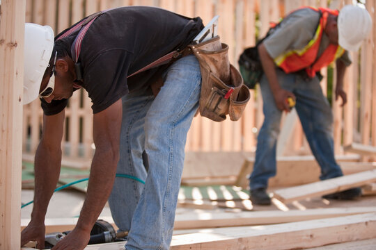 Carpenters working on house framing