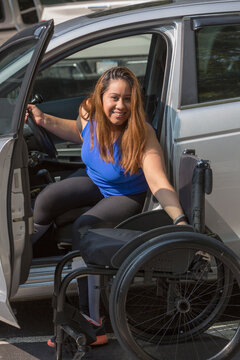 Woman with a spinal cord injury getting out of her car