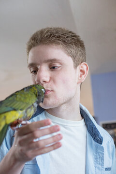 Boy with Anxiety Disorder playing with his pet bird