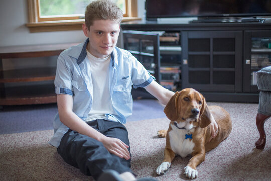 Man with Anxiety Disorder sitting with his therapy dog